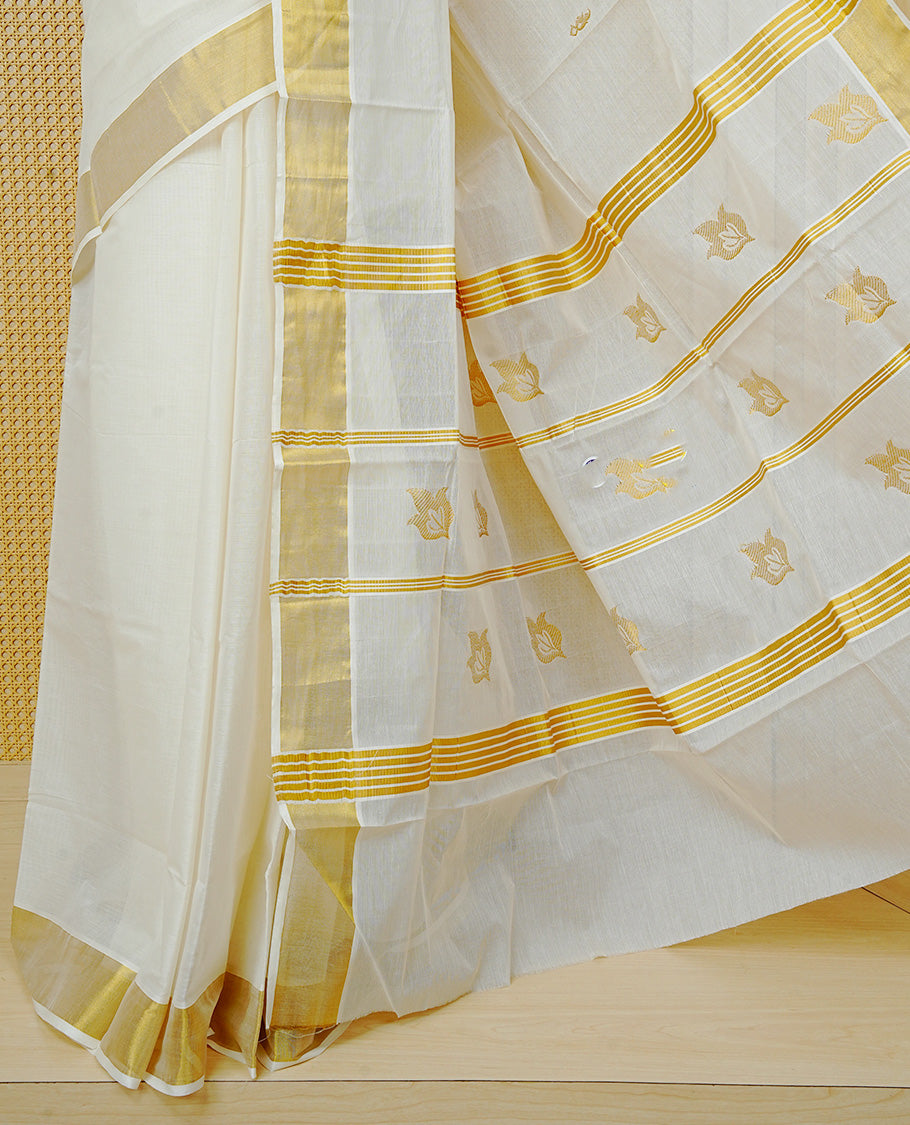 Cream Colour Cotton  Kerala Saree Featuring a Classic Gold Zari Border and Delicate Gold Leafs Motifs Across the Pallu. Finished with Fine Gold Stripes for a Timeless Traditional Look, Paired with a Matching Blouse Piece.