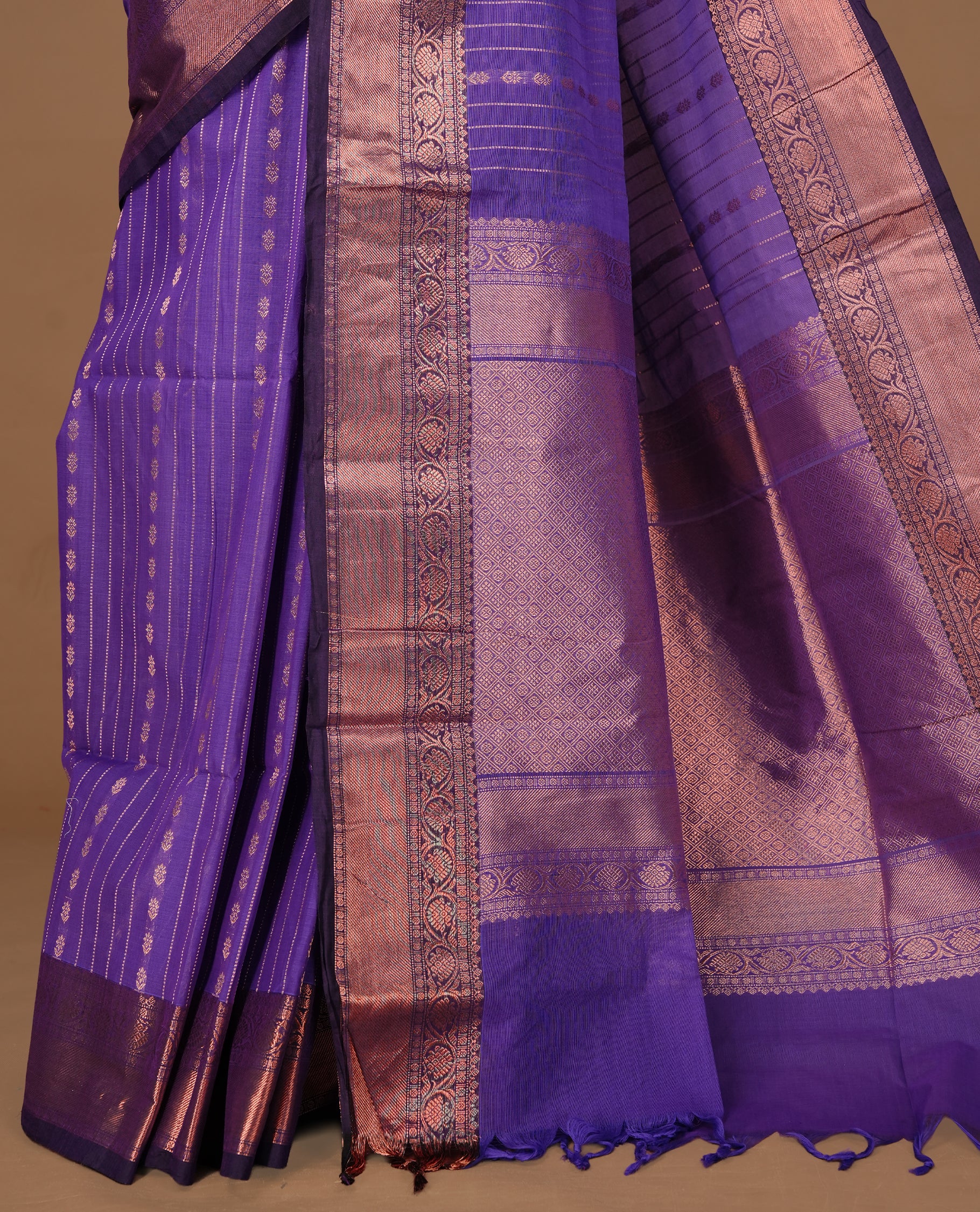 Violet Colour Chettinad cotton saree featuring Gold zari Stripes on body, complemented by contrast Dark purple colour with traditional border, paired with matching blouse piece.