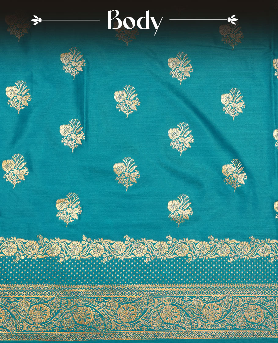 Teal blue colour Banaras Satin Crepe saree featuring gold zari floral motifs on the body, a richly woven traditional border with intricate gold zari detailing, and paired with a matching blouse.