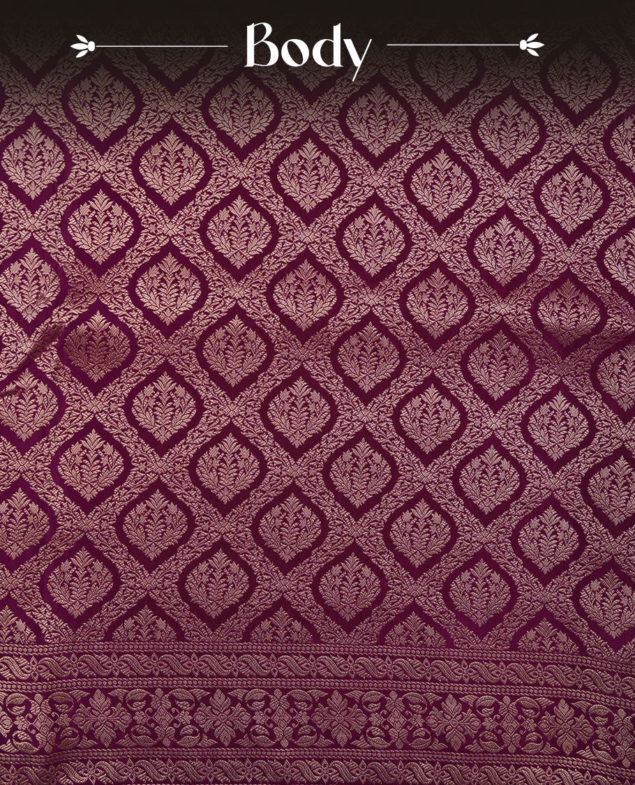 Grape colour banaras satin crepe saree featuring gold zari pattern across body, with self colour border with gold zari pattern and paired with matching blouse.