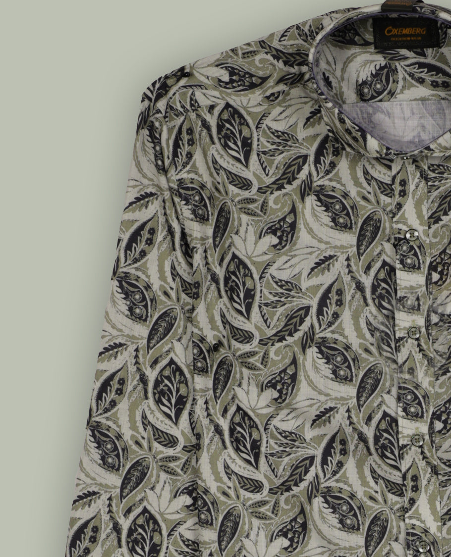 Olive green colour leaf printed full sleeve shirt featuring an all over hand drawn botanical design, Styled with a neat mandarin collar and button down front, offering a trendy and refreshing look.