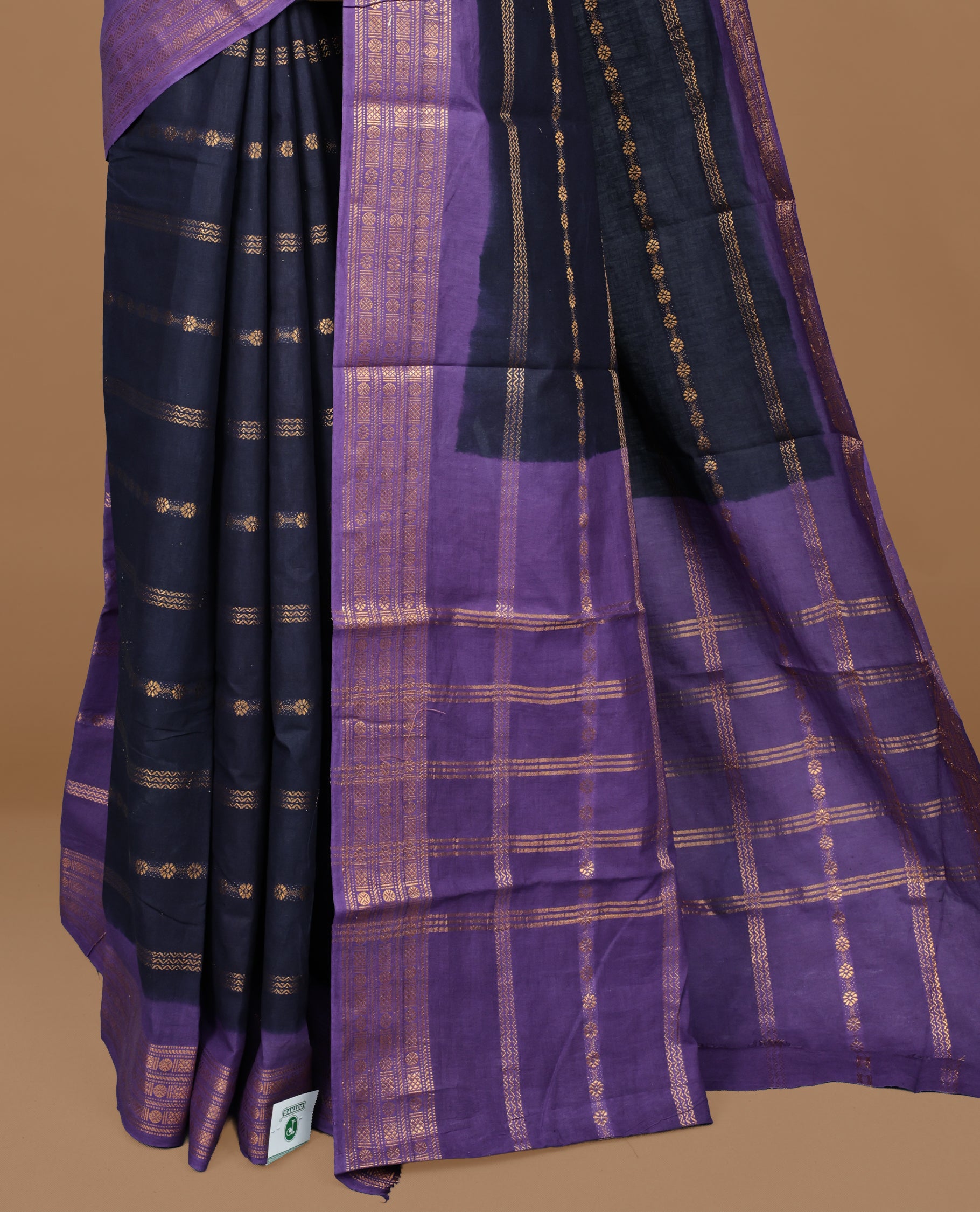 Navy Blue colour Sungudi cotton saree featuring Gold zari Stripes on body, Gold zari on Contrast Purple colour border, paired with matching blouse piece.