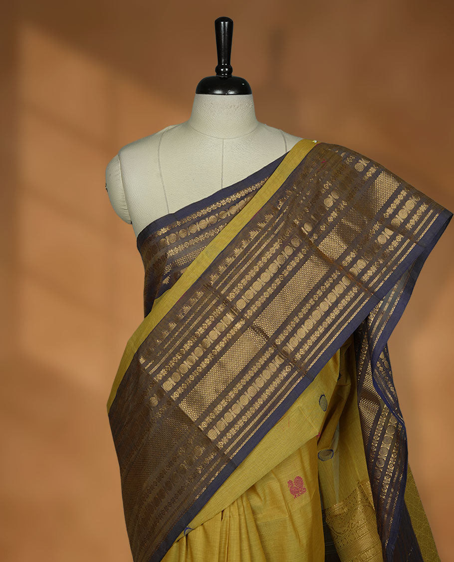 Olive colour chettinad cotton saree featuring Purple colour motifs on body, contrast purple colour border with gold zari border, pallu and paired with matching blouse.