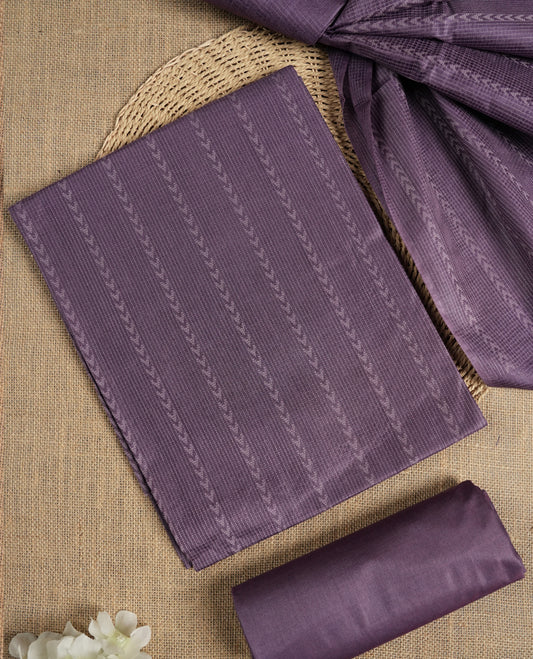 Lavender colour tussar suit material adorned with intricate woven patterns and subtle motifs, exuding ethnic elegance & Paired with a beautifully bordered dupatta and a matching plain bottom.