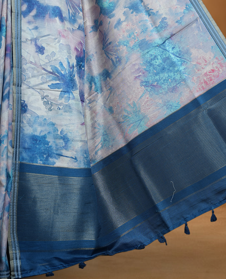 Sky blue colour semi tussar silk saree featuring a dreamy abstract digital floral printed body, finished with a rich self border and tasselled pallu, paired with a matching blouse.