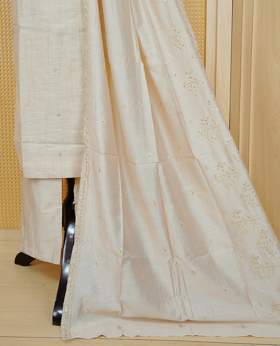 Beige colour churidar set featuring delicate floral embroidery on the yoke, paired with matching solid pants and an embroidered dupatta