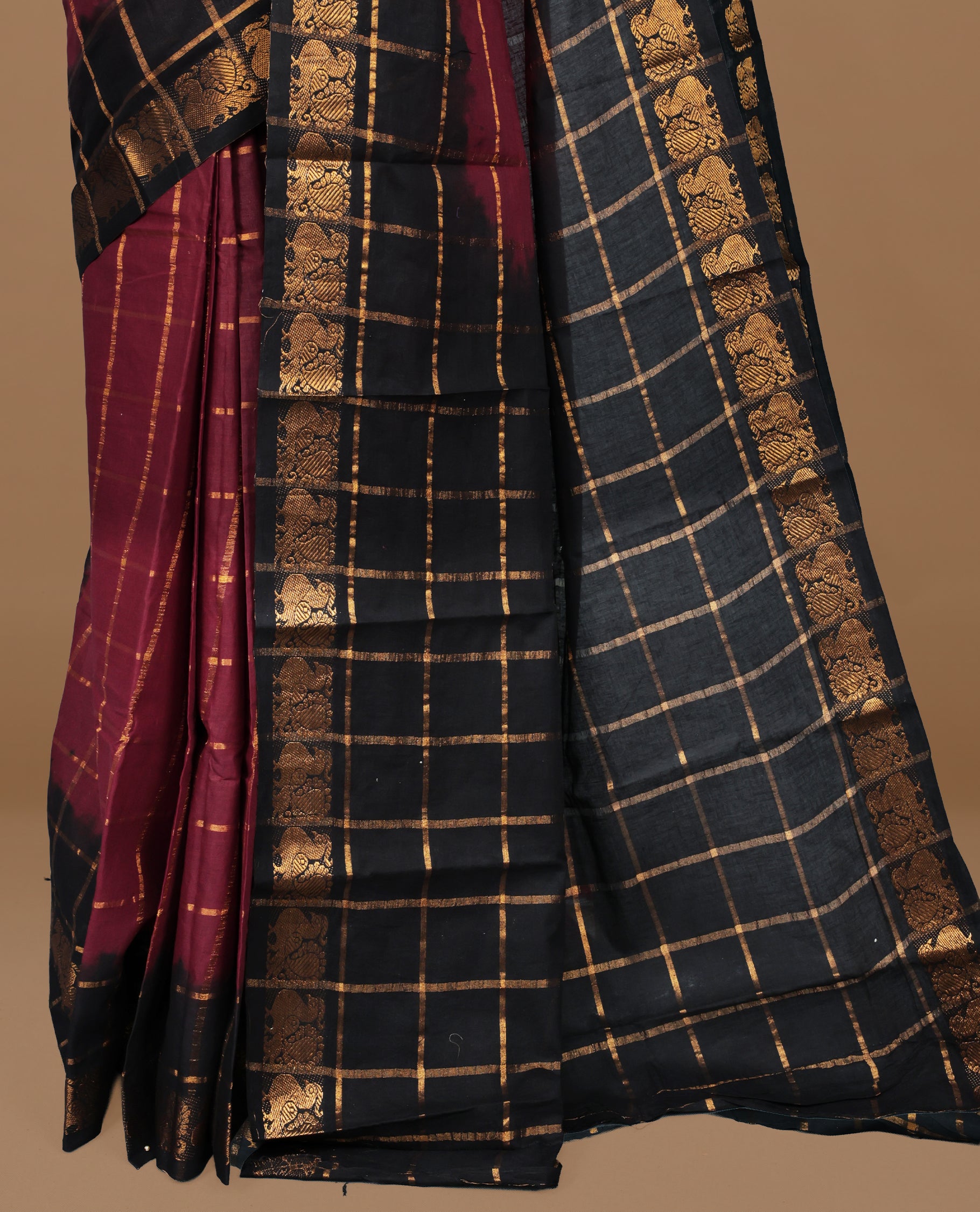 Maroon colour Sungudi cotton saree featuring Gold zari Check pattern on body, Gold zari Peacock design on Dyed Black colour design border, paired with matching blouse piece.