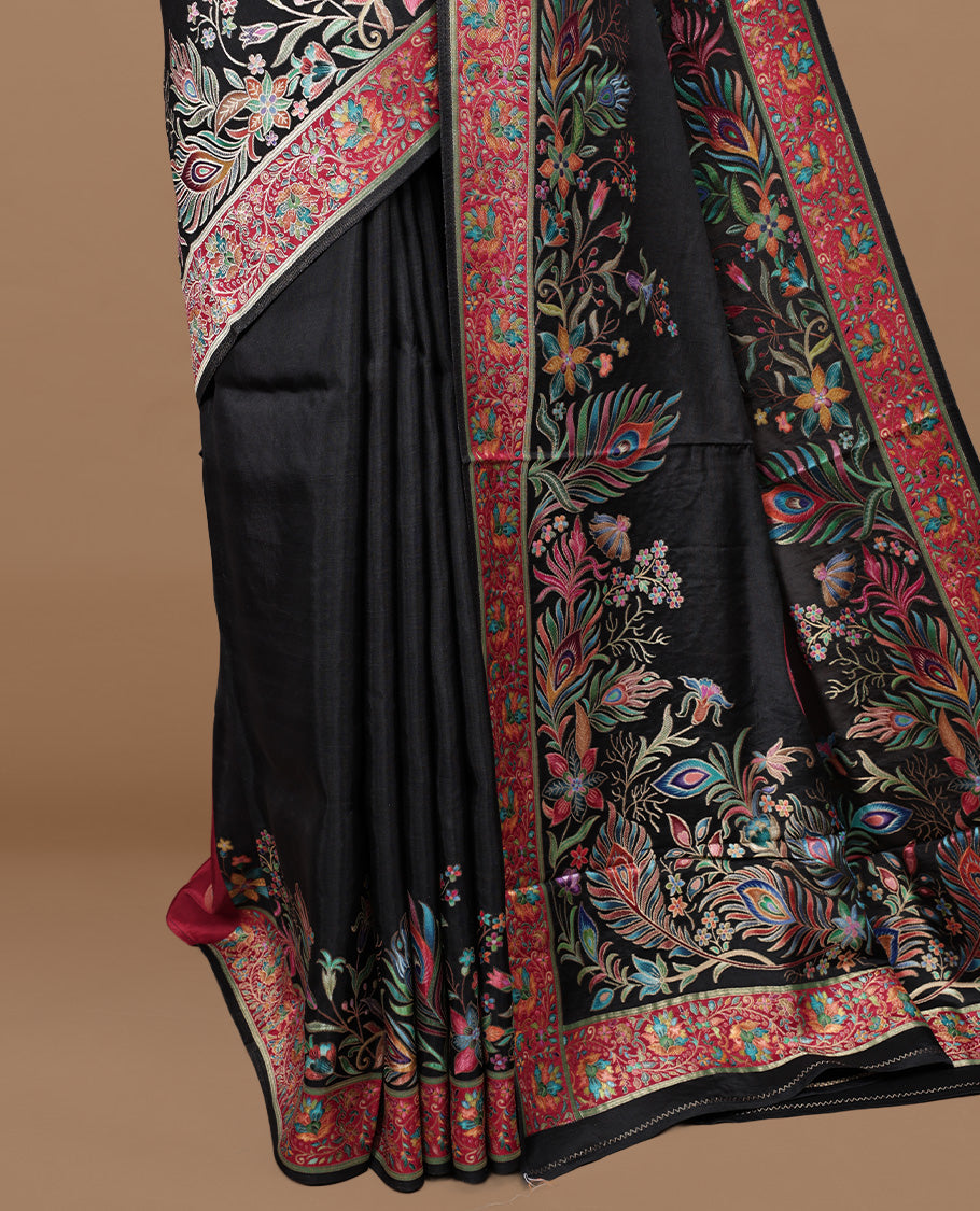 Black colour pashmina saree featuring Multi colour floral kodi & peacock leaf patterned border and pallu, paired with matching blouse piece.