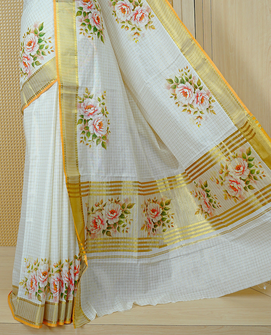 Cream Colour Kerala Saree Featuring Gold Zari Checks On The Body, Enhanced By A Gold Zari Border With Floral Prints And A Matching Pallu, Paired With A Matching Blouse Piece.