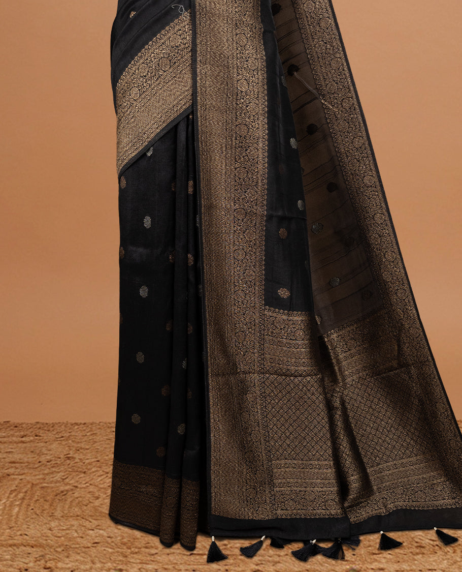 Black colour Semi banaras tussar georgette Saree featuring Antique zari motifs on body, enhanced with antique zari border, paired with a matching blouse piece.