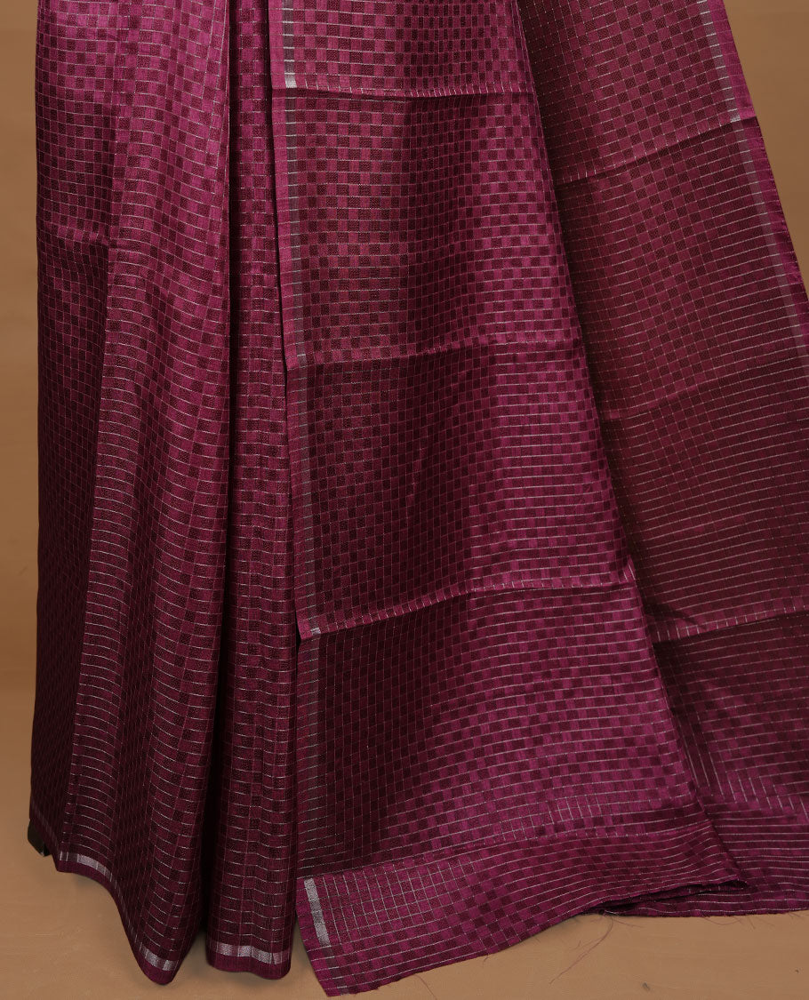 Grape colour Semi Tussar saree featuring an elegant zari fancy check pattern on the body, highlighted with a small border for a refined look. Comes without a blouse piece.