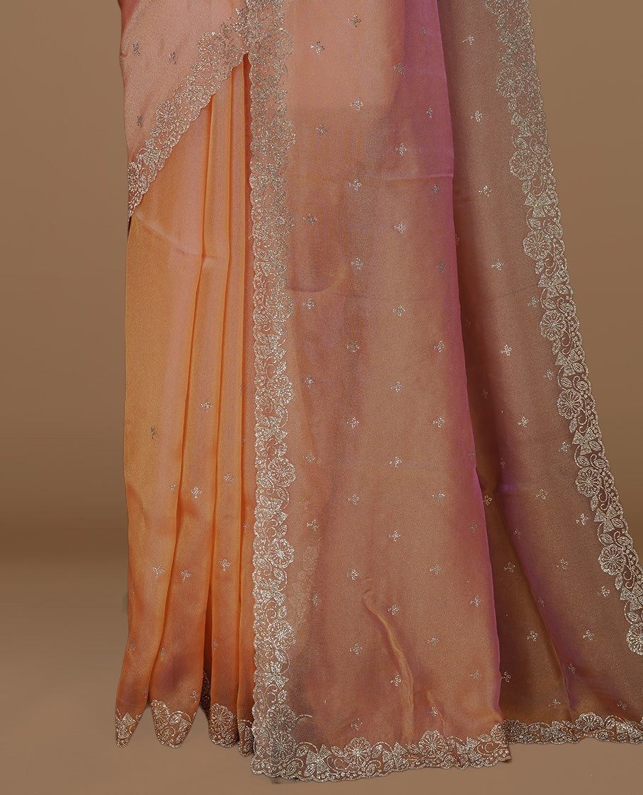 Pinkish orange colour designer saree featuring stone worked body, stone worked border, paired with matching blouse piece.