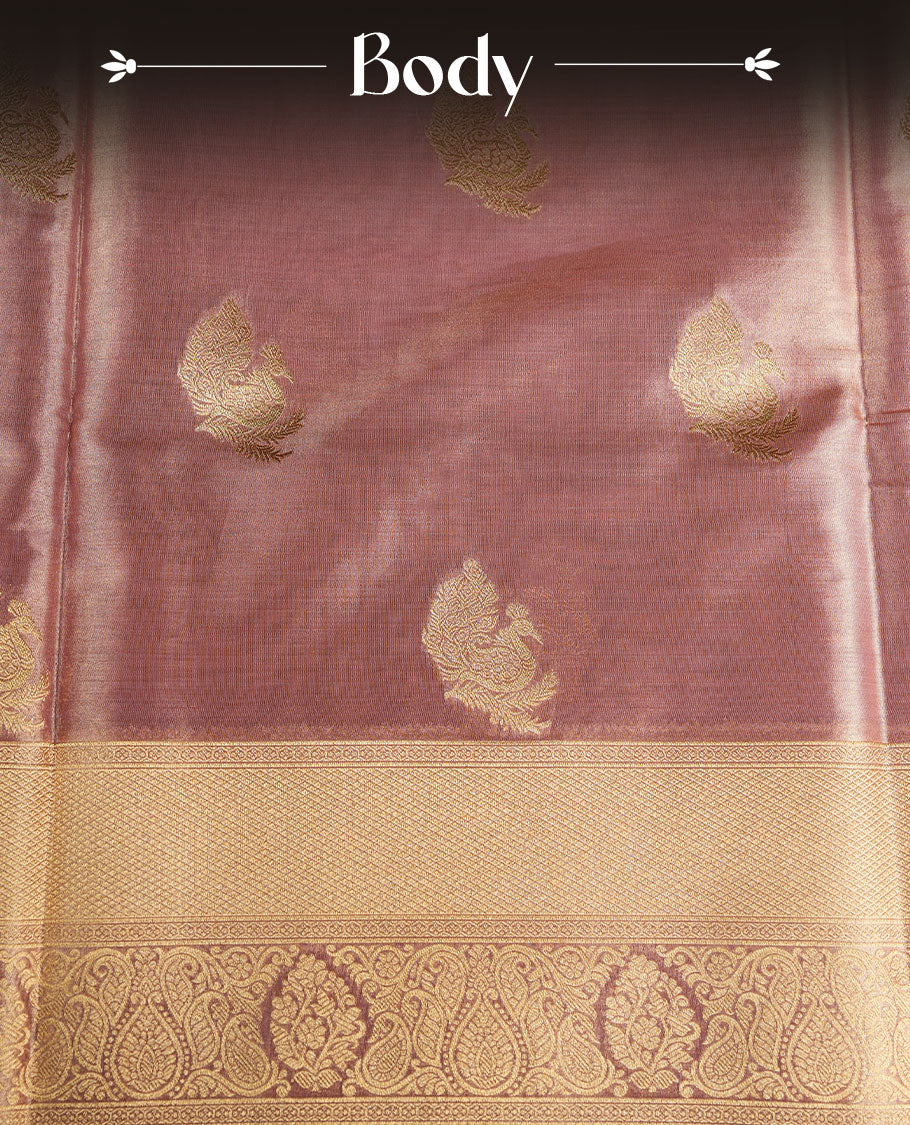 Dual tone light peach and pink colour tissue brocade saree featuring antique gold zari motifs on the body with a rich traditional zari border and pallu, paired with a matching blouse piece.