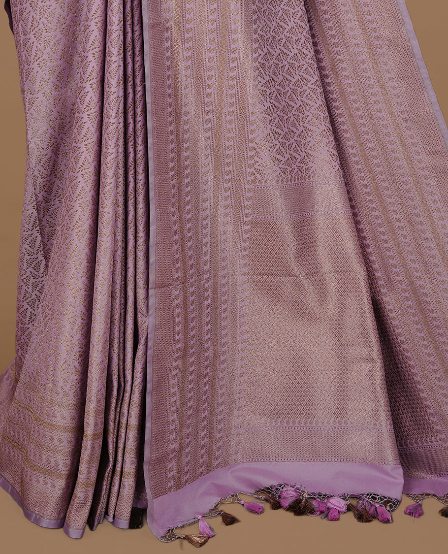 Lavender colour Semi Banaras Katan saree featuring Antique zari Floral pattern on body, complemented by self colour zari border, paired with matching blouse piece.