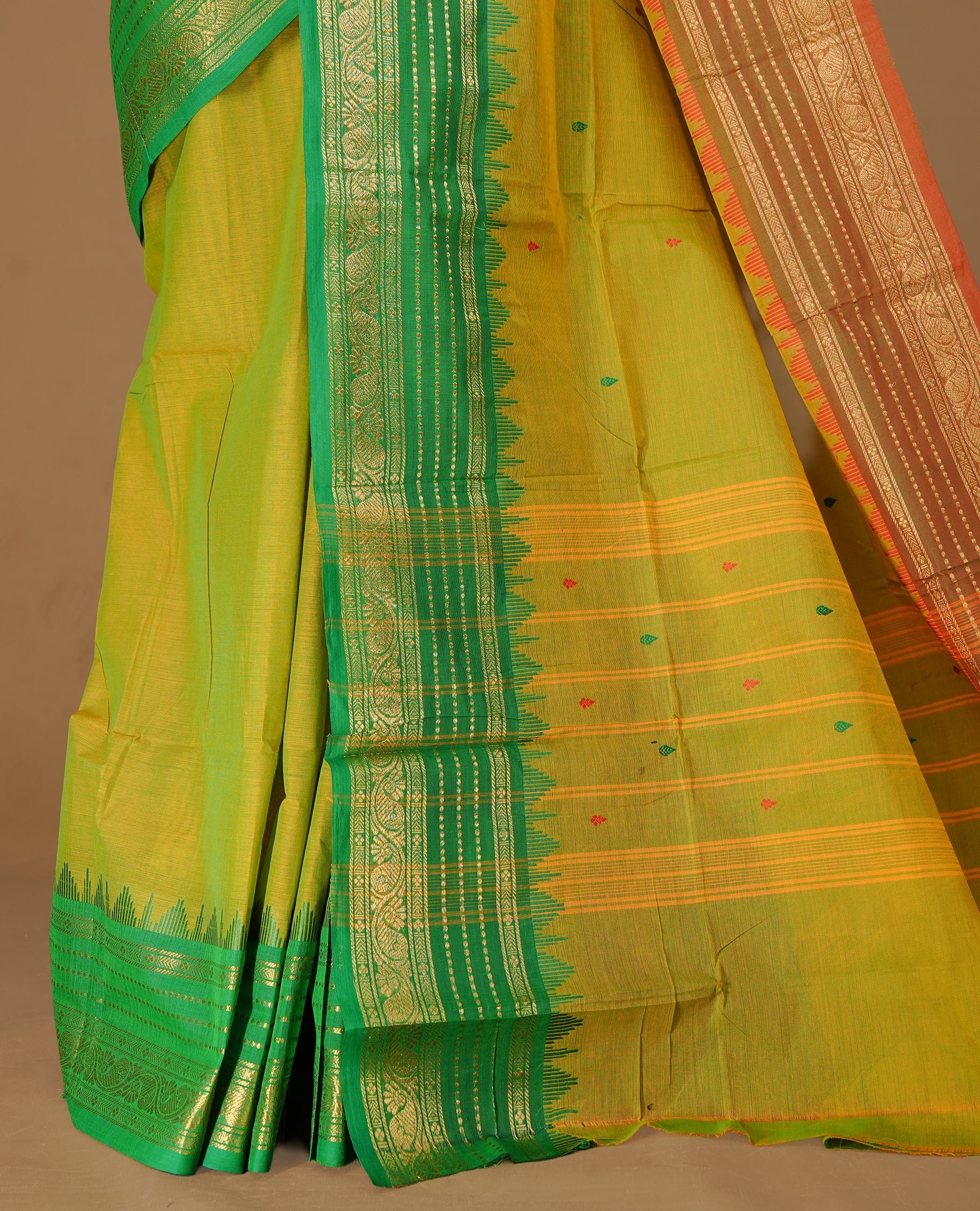 Moderate Olive colour Chettinad cotton saree featuring motifs on body , complemented by contrast Green colour with zari border, comes with matching blouse piece.
