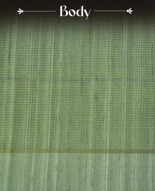 Light jade colour semi tussar silk saree featuring elegant gold zari dotted stripes across the body, enhanced with a rich zari woven border. Comes with a matching blouse piece.