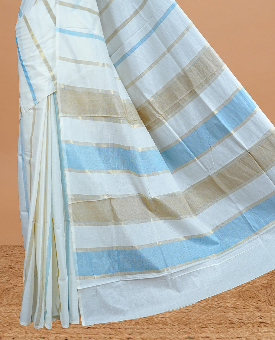 Cream Colour Cotton Kerala Saree Featuring Light Blue & Gold Zari Strips On The Body & Pallu, Paired With A Matching Blouse Piece.