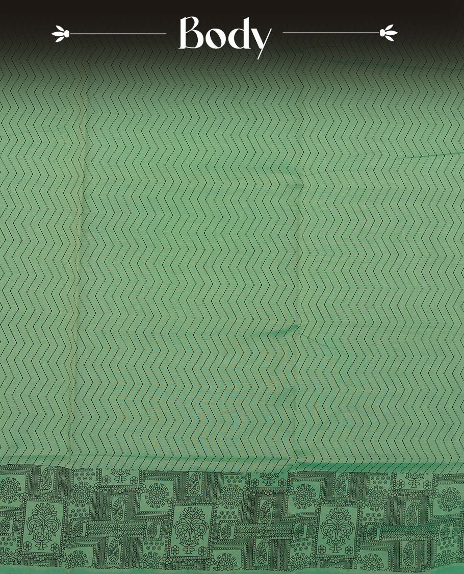 Pista Green colour poly cotton saree with black zigzag line pattern on the body, paired with a matching pallu featuring black chevron lines and panelled floral‑paisley design, and a coordinated all‑over floral paisley patch‑style printed blouse piece.