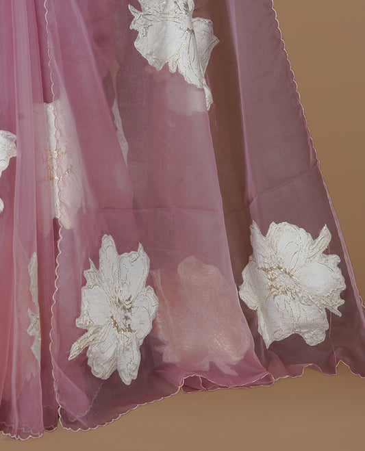 Pastel Mauve colour semi organza saree featuring white floral & gold thread pattern, highlighting scalp design border, paired with matching blouse piece.