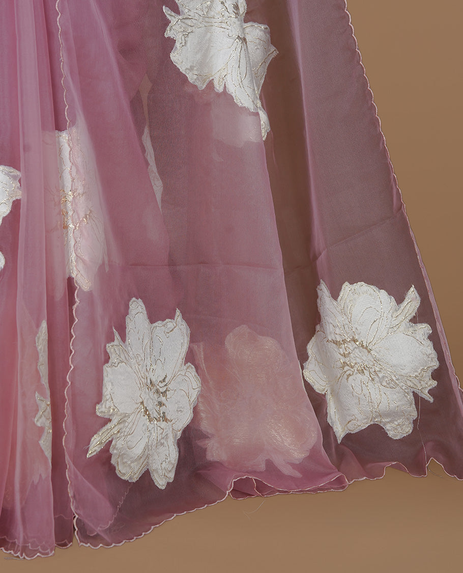Pastel Mauve colour semi organza saree featuring white floral & gold thread pattern, highlighting scalp design border, paired with matching blouse piece.