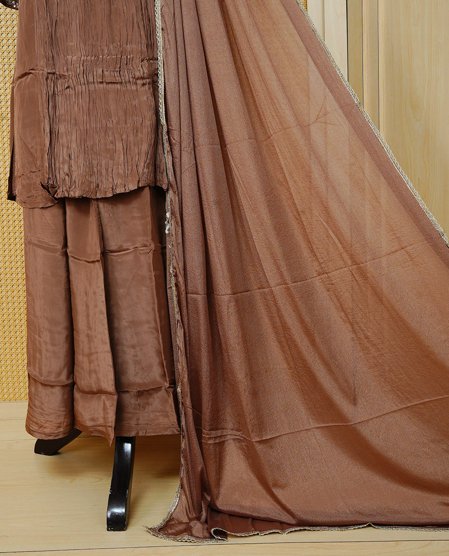 Pastel brown colour churidar set with bead and sequin floral embroidery on the yoke, a delicately embellished neckline and sleeve cuffs, paired with a matching bordered dupatta and solid pants.