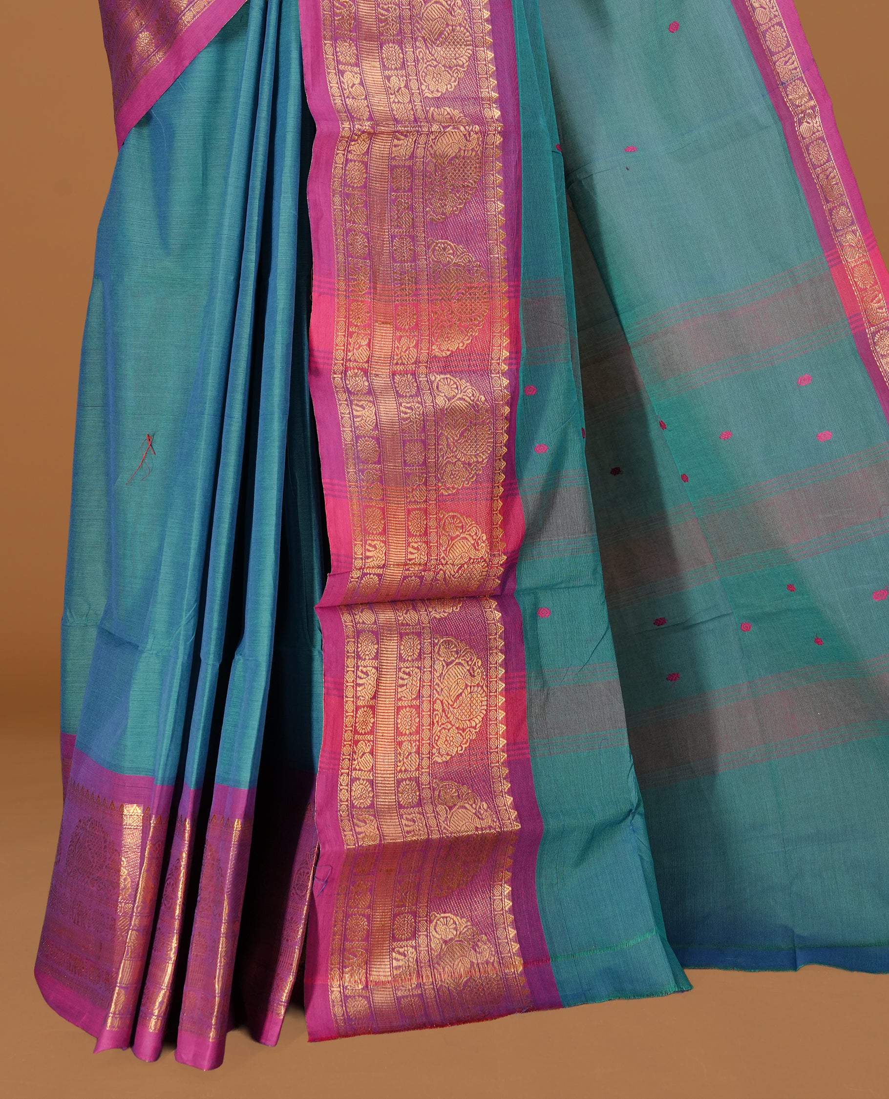 Teal colour Chettinad cotton saree featuring motifs on body , complemented by contrast Magenta colour with zari border, comes with matching blouse piece.