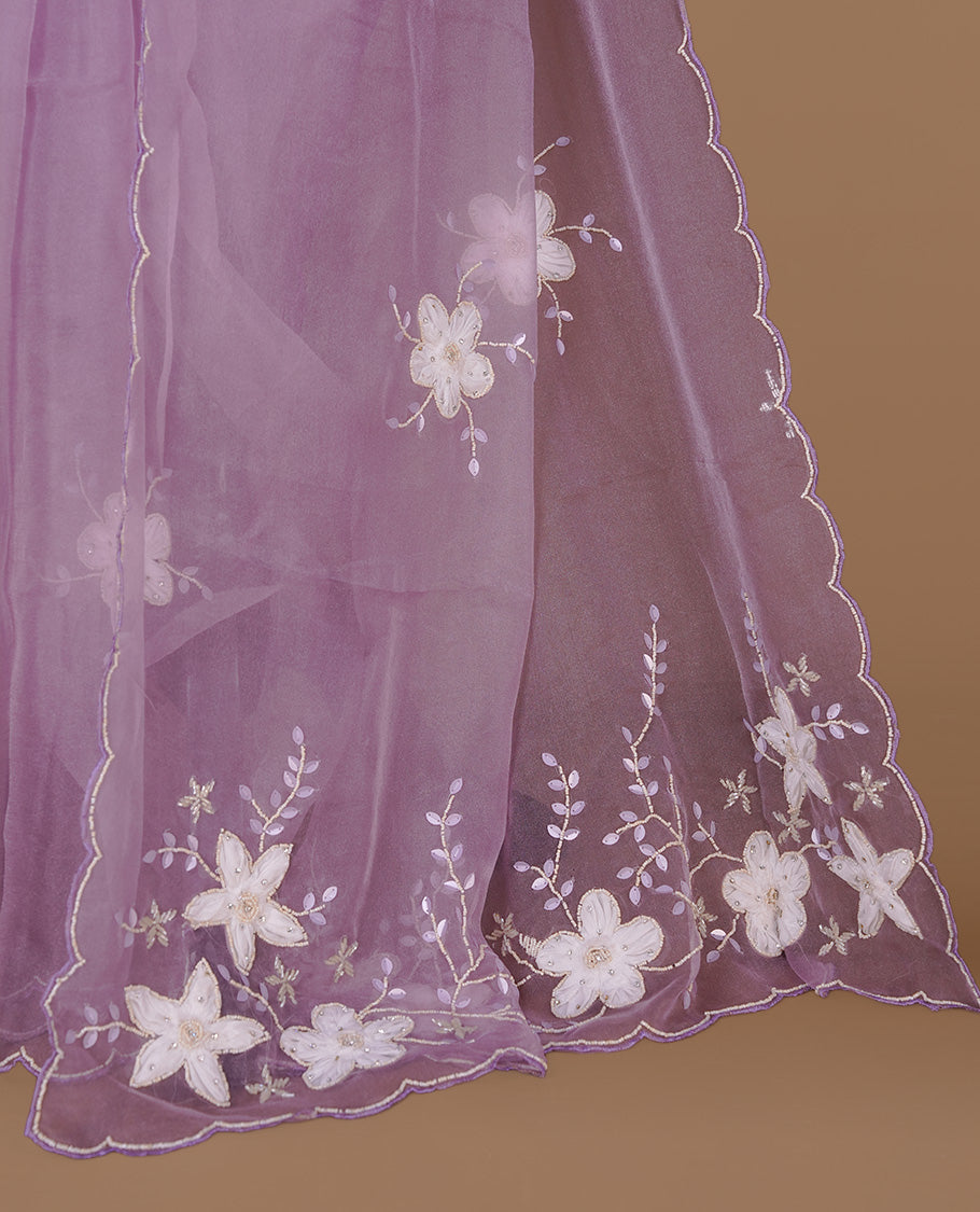 Pastel lavender colour crush organza saree featuring white floral work with beats & sequins, highlighting scalp with beats worked border, paired with matching blouse piece.