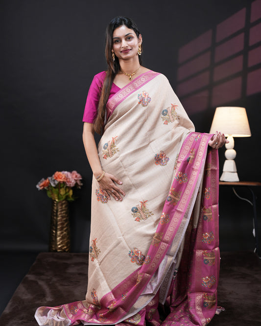Cream Colour Moss chiffon saree featuring Peacock & Floral prints on the body, Pink Colour double border with Floral prints and a contrast designed pallu, paired with a contrast designed blouse piece.