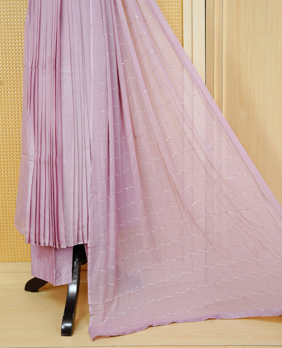 Nude pink colour churidar set with sequins and bead embroidery on the V-neckline, paired with a matching embellished dupatta and solid pants.