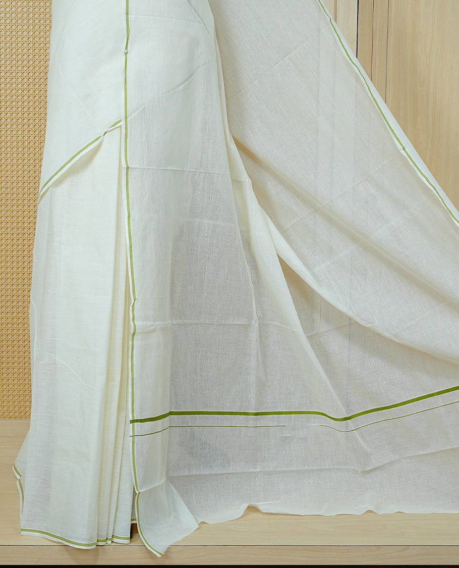 Cream colour cotton Kerala saree Featuring Classy Plain body for Effortless Elegance, enhancing Minimalist Green border, paired with matching blouse piece.