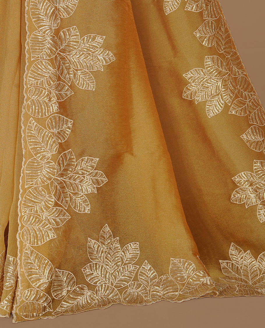Gold colour organza saree featuring thread & cut beats, sequins leaf pattern on body, highlighting scalp border, paired with matching blouse piece.