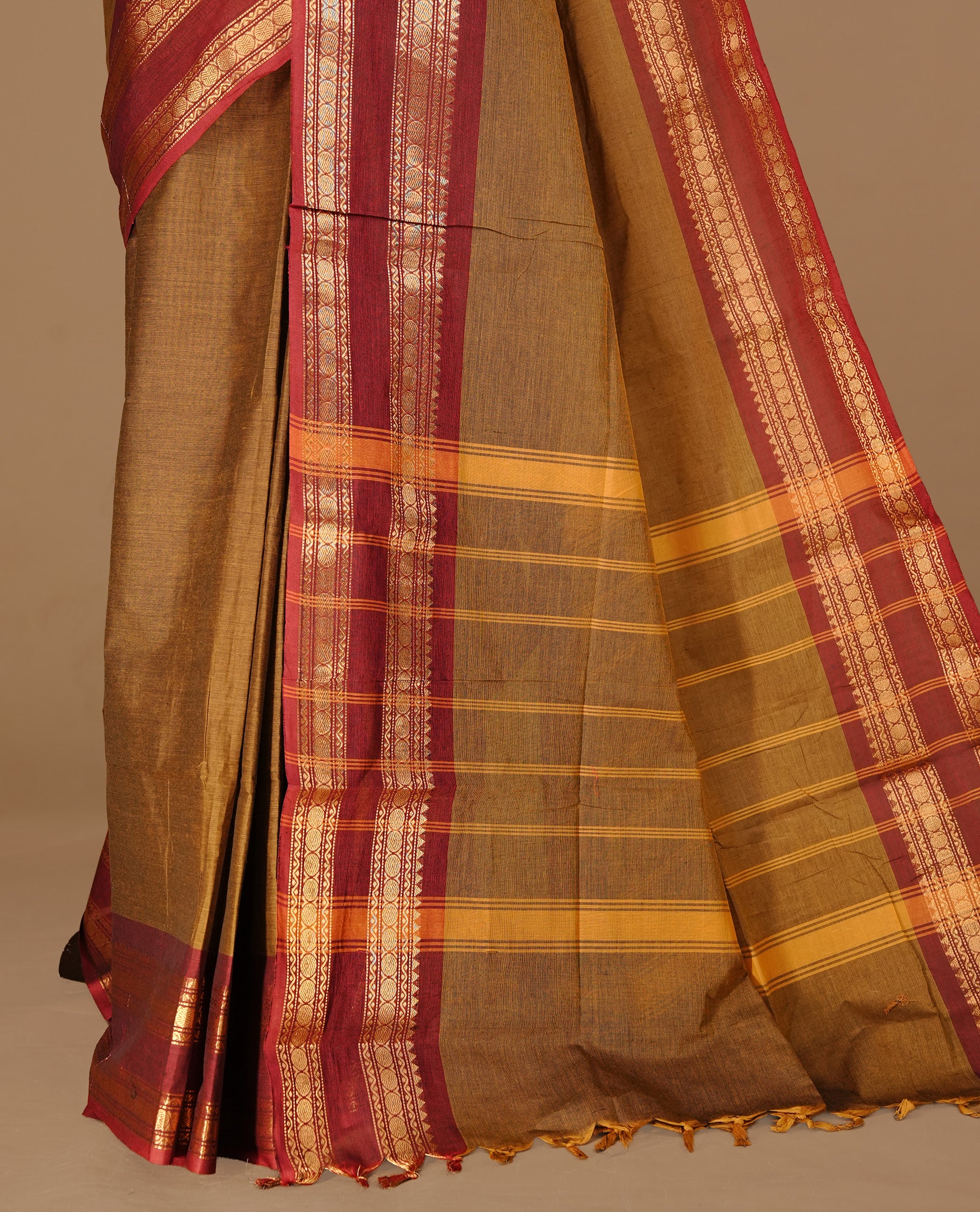 Dark olive colour Chettinad cotton saree featuring Elegant plain body, complemented by contrast Maroon colour with gold zari border, paired with matching blouse piece.