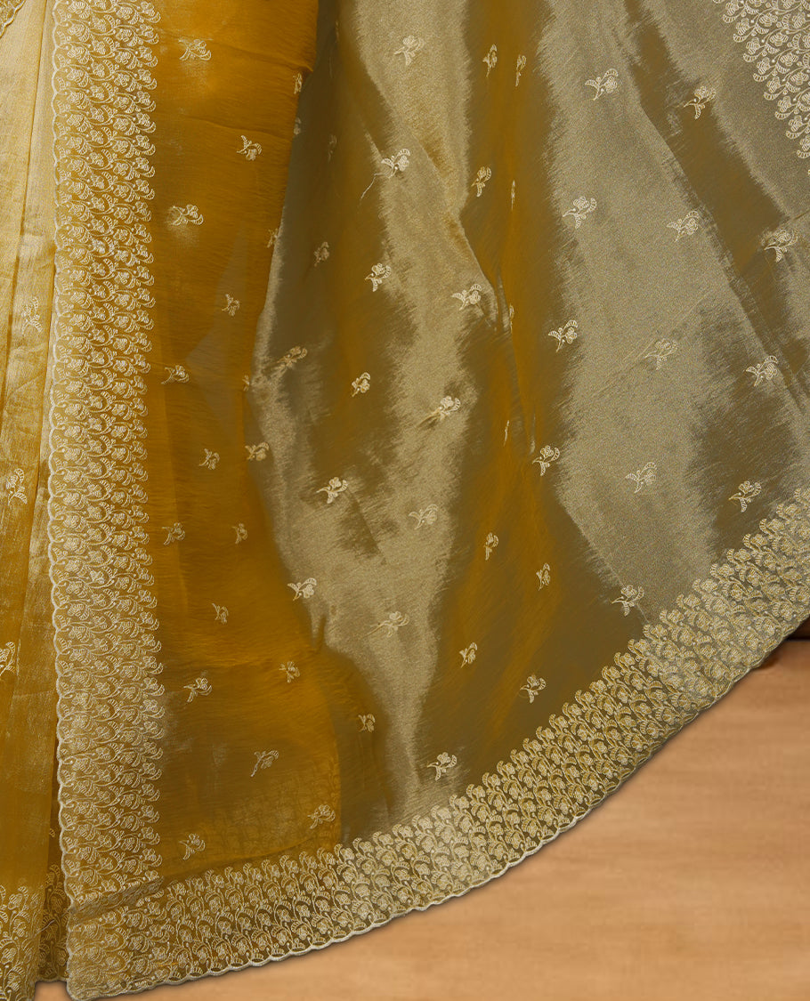 Pastel yellow colour organza saree featuring white thread embroidery motifs on body and  thread detailing on the border and paired matching blouse.