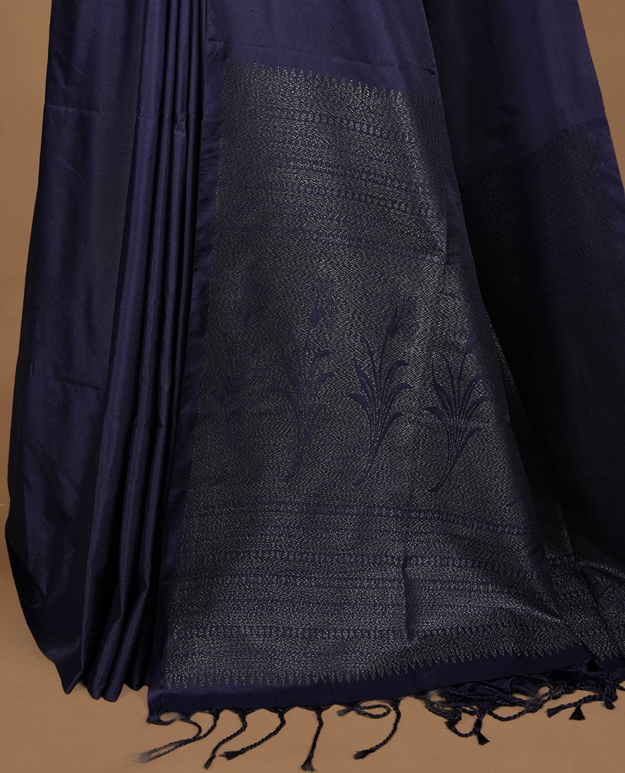 Navy Blue soft silk saree features a sleek borderless design with intricate antique zari motifs, flowing into a seamless self colored pallu and a matching blouse piece.