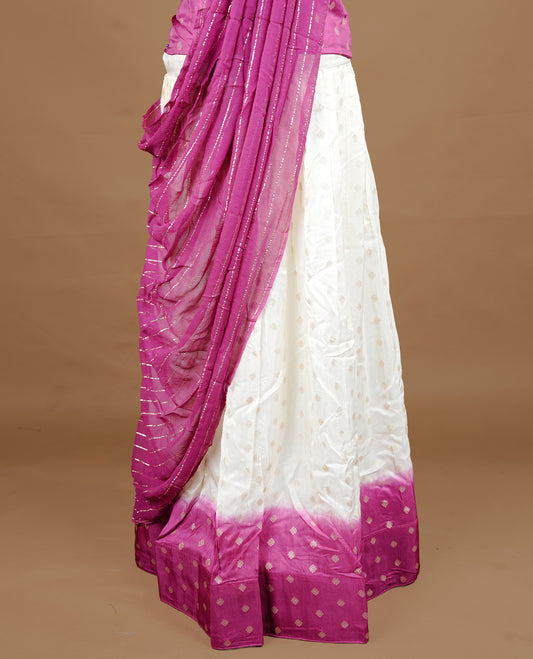 Off White colour semi stitched half saree material featuring delicate zari buttas on the blouse and skirt, paired with a contrast pink zari border and matching striped dupatta