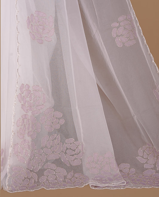 White colour net orange saree featuring pastel purple floral pattern with cut beats on body, highlighting scalp border, paired with matching blouse piece.