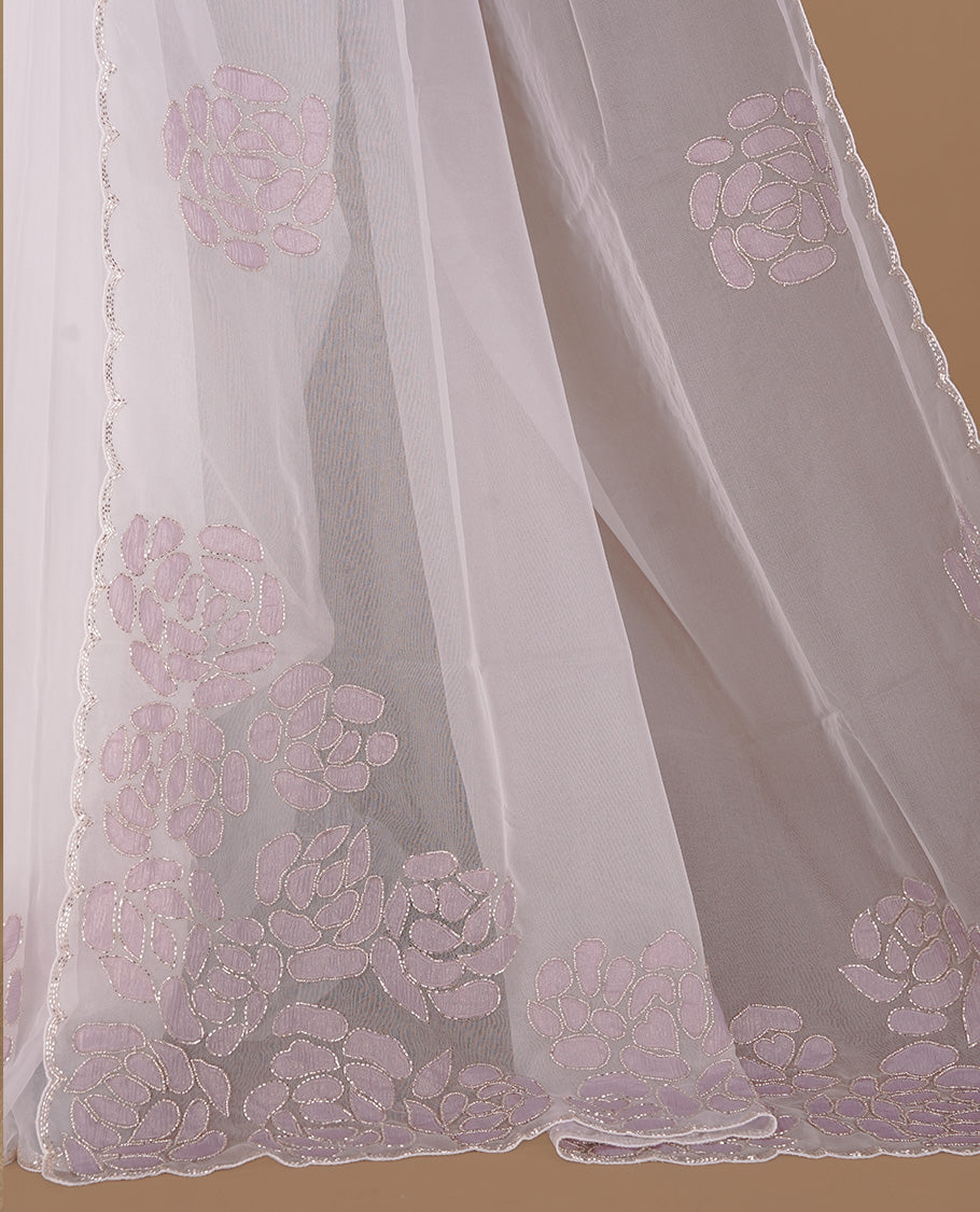 White colour net orange saree featuring pastel purple floral pattern with cut beats on body, highlighting scalp border, paired with matching blouse piece.