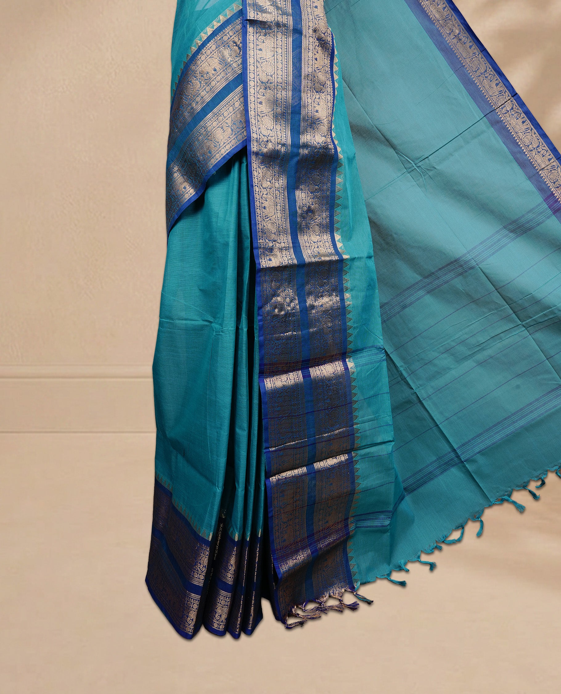 Aqua colour Chettinad cotton saree featuring Elegant plain body, complemented by contrast Teal colour with Gold zari border, paired with matching blouse piece.