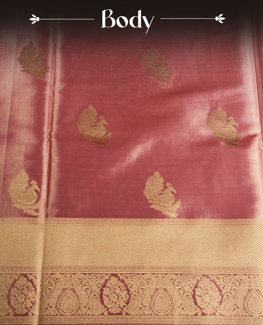 Dual tone peach and dark pink colour tissue brocade saree featuring antique gold zari motifs on the body with a rich traditional zari border and pallu, paired with a matching blouse piece.