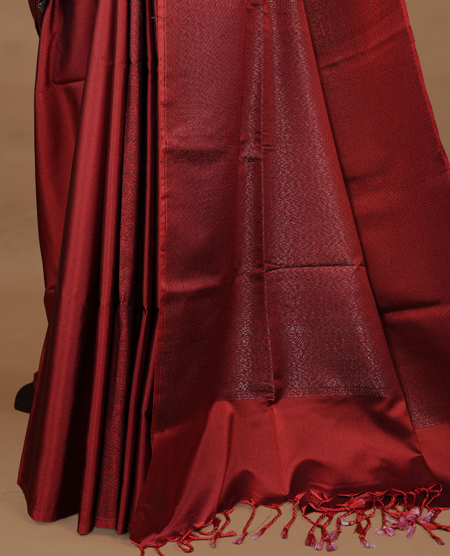 Red soft silk saree features a sleek borderless design with intricate antique zari motifs, flowing into a seamless self colored pallu and a matching blouse piece.