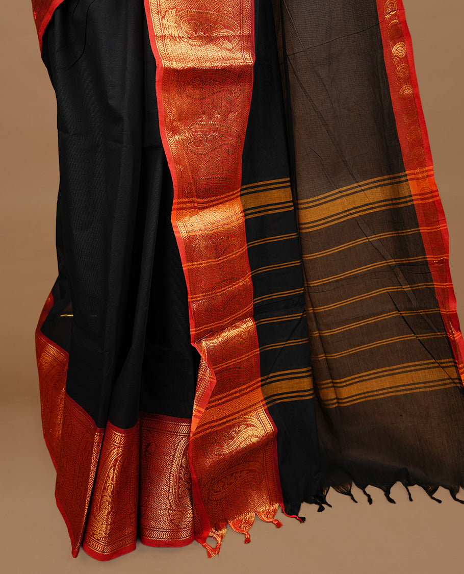 Black colour chettinad cotton saree featuring elegant plain body, complemented by red colour with zari border, paired with matching blouse piece.