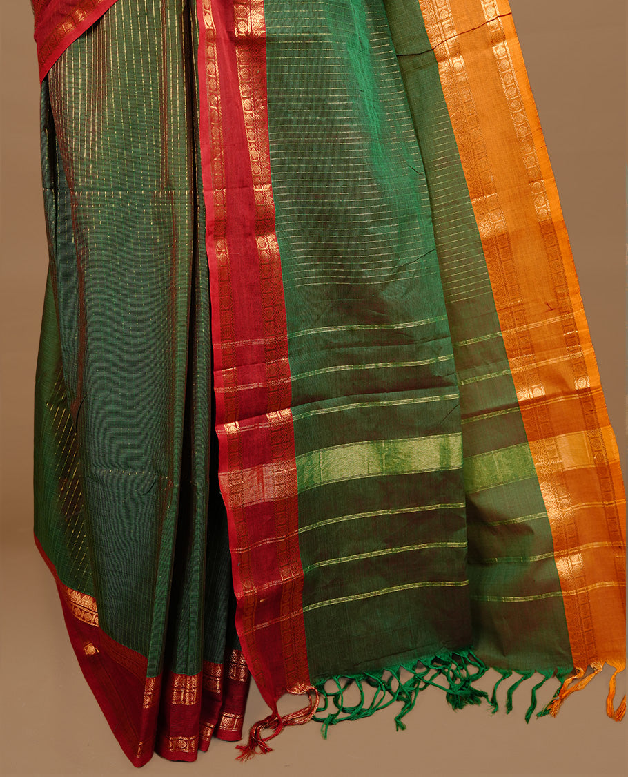 Green colour chettinad cotton saree featuring gold zari stripes on body, complemented by red colour with zari border, paired with matching blouse piece.