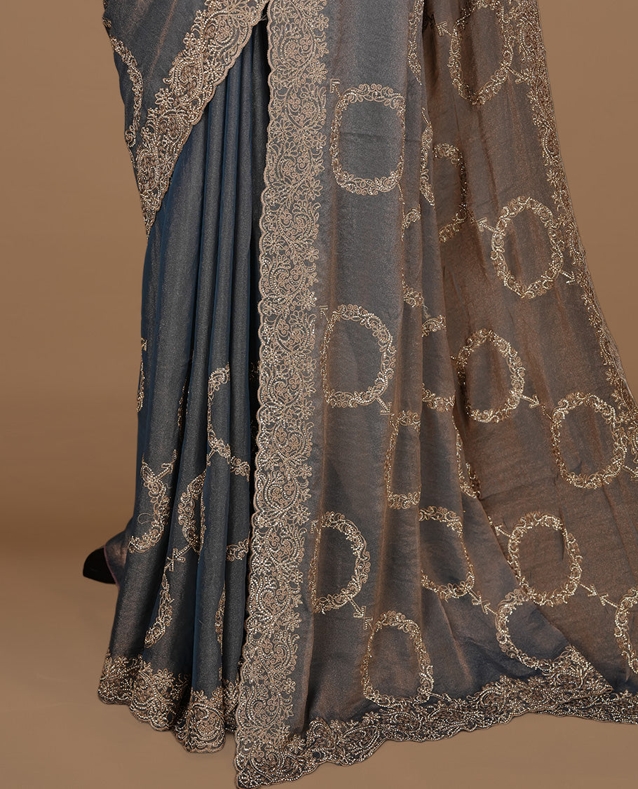 Blue colour organza saree featuring thread & gold stone pattern on body, highlighting scalp border, paired with mtahcing blouse piece.