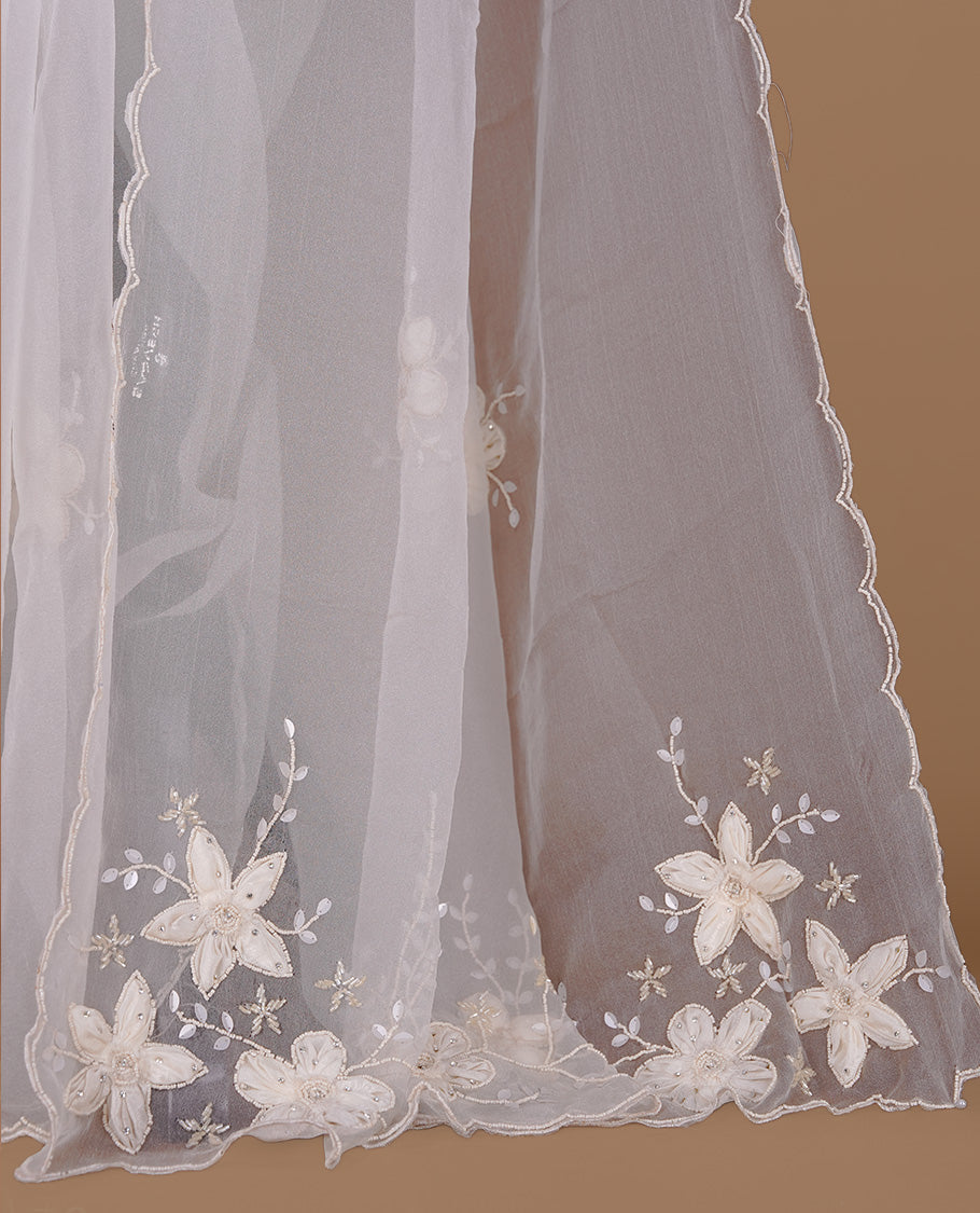 White colour crush organza saree featuring white floral work with beats & sequins, highlighting scalp with beats worked border, paired with matching blouse piece.