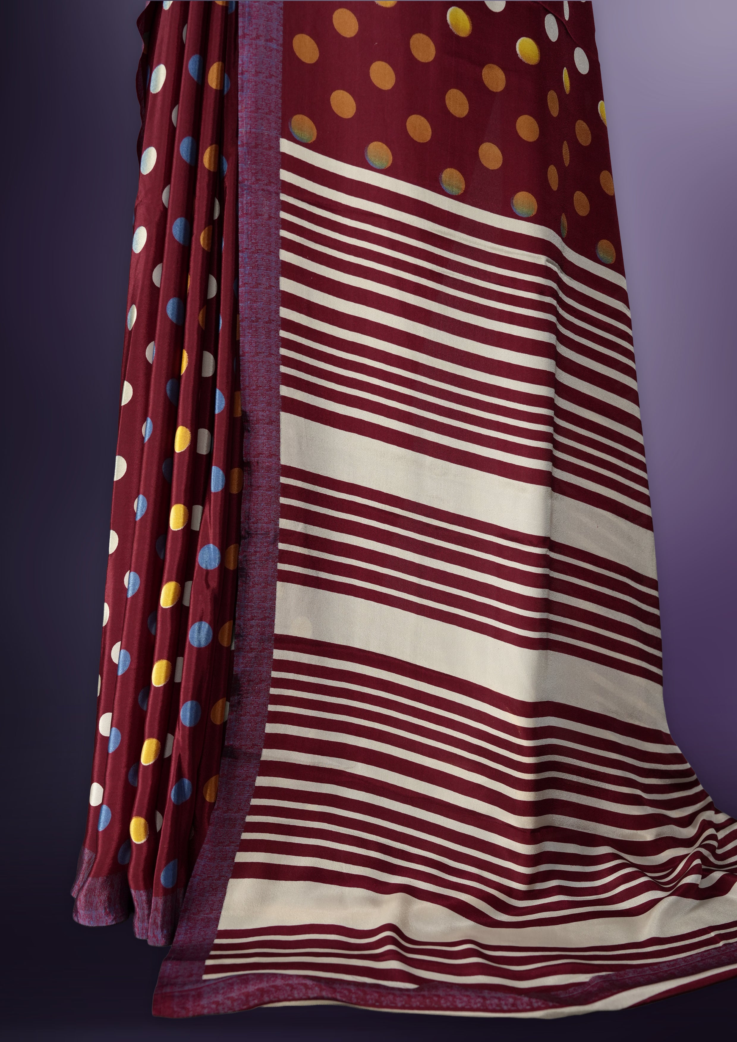 Maroon colour saree with with large big polka dots on the body, self stripped pallu & Comes with a stylish matching blouse.