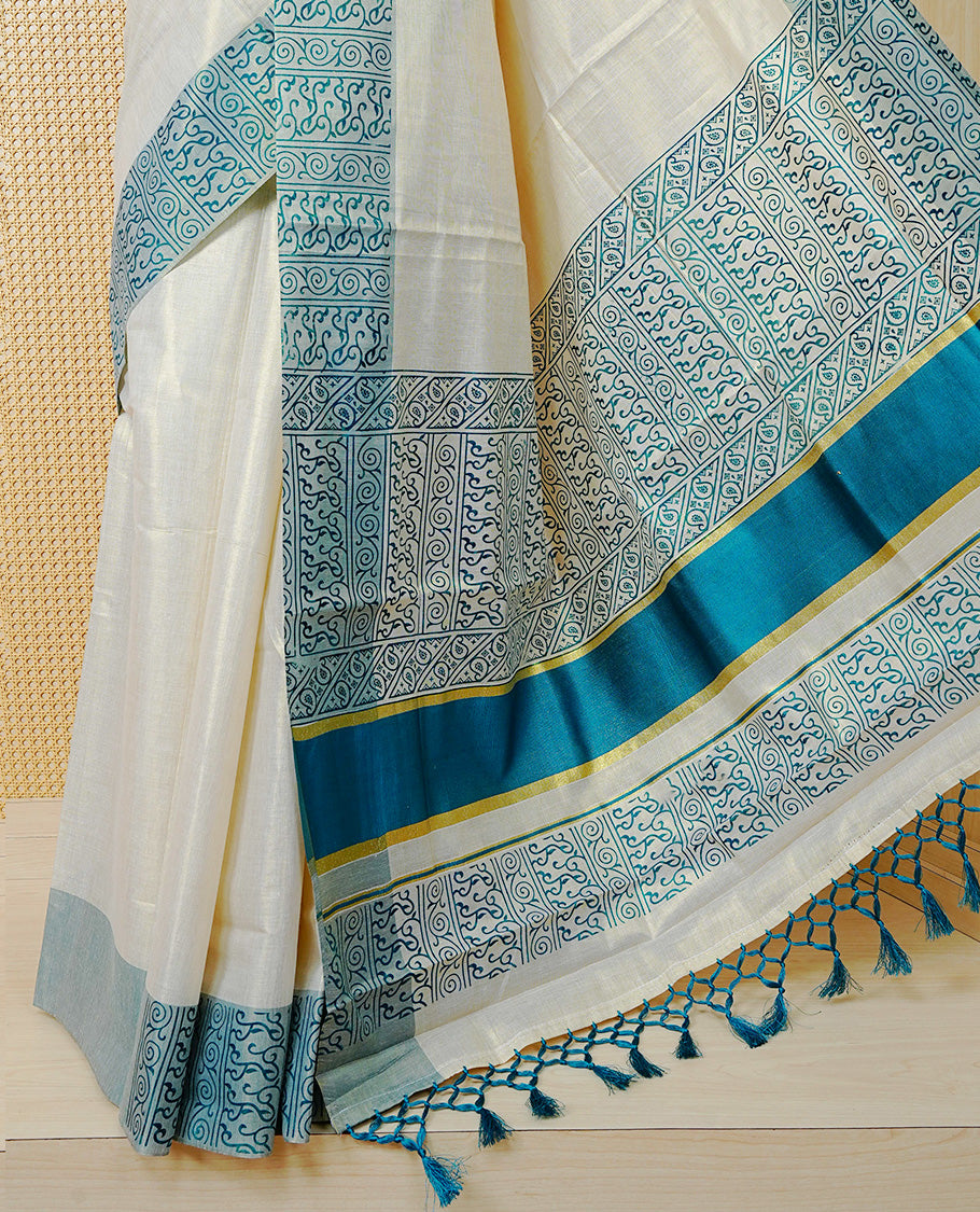 Cream Colour Tissue Kerala Saree Featuring a Plain Body, Enhanced with Sea Green Block  Printed Borders, a Sea Green and Gold Zari Pallu, Sea Green Tassels, and a Matching Blouse Piece.