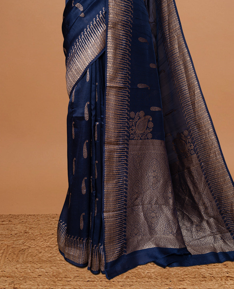 Navy Blue colour Semi Banaras Tussar Georgette Featuring Gold zari Leaf pattern on body, Finished with Gold zari border and paired with matching blouse piece.