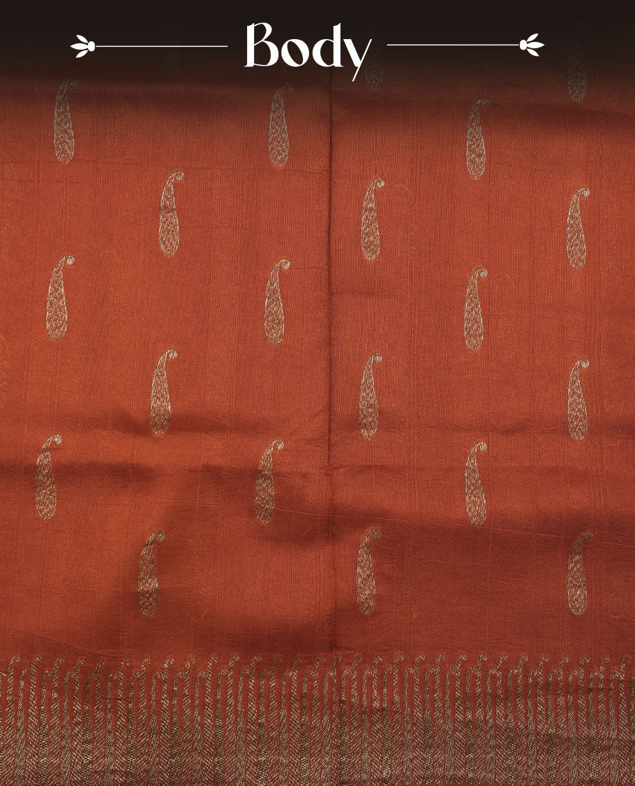 Burnt orange colour semi banaras tussar georgette featuring gold zari leaf pattern across body, finished with gold zari border and paired with matching blouse.