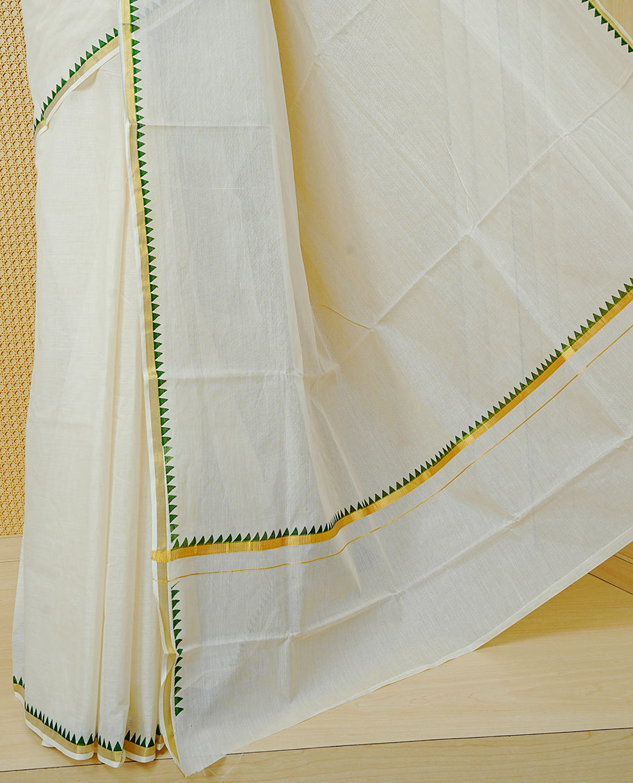 Cream  Colour cotton Kerala saree Featuring  with a gold zari border and green temple edging. Paired with a matching blouse piece.