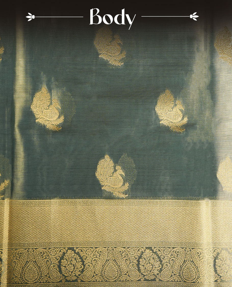 Dual tone teal and gold colour tissue brocade saree featuring antique gold zari motifs on the body with a rich traditional zari border and pallu, paired with a matching blouse piece.